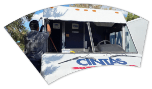 Technician performing a windshield replacement