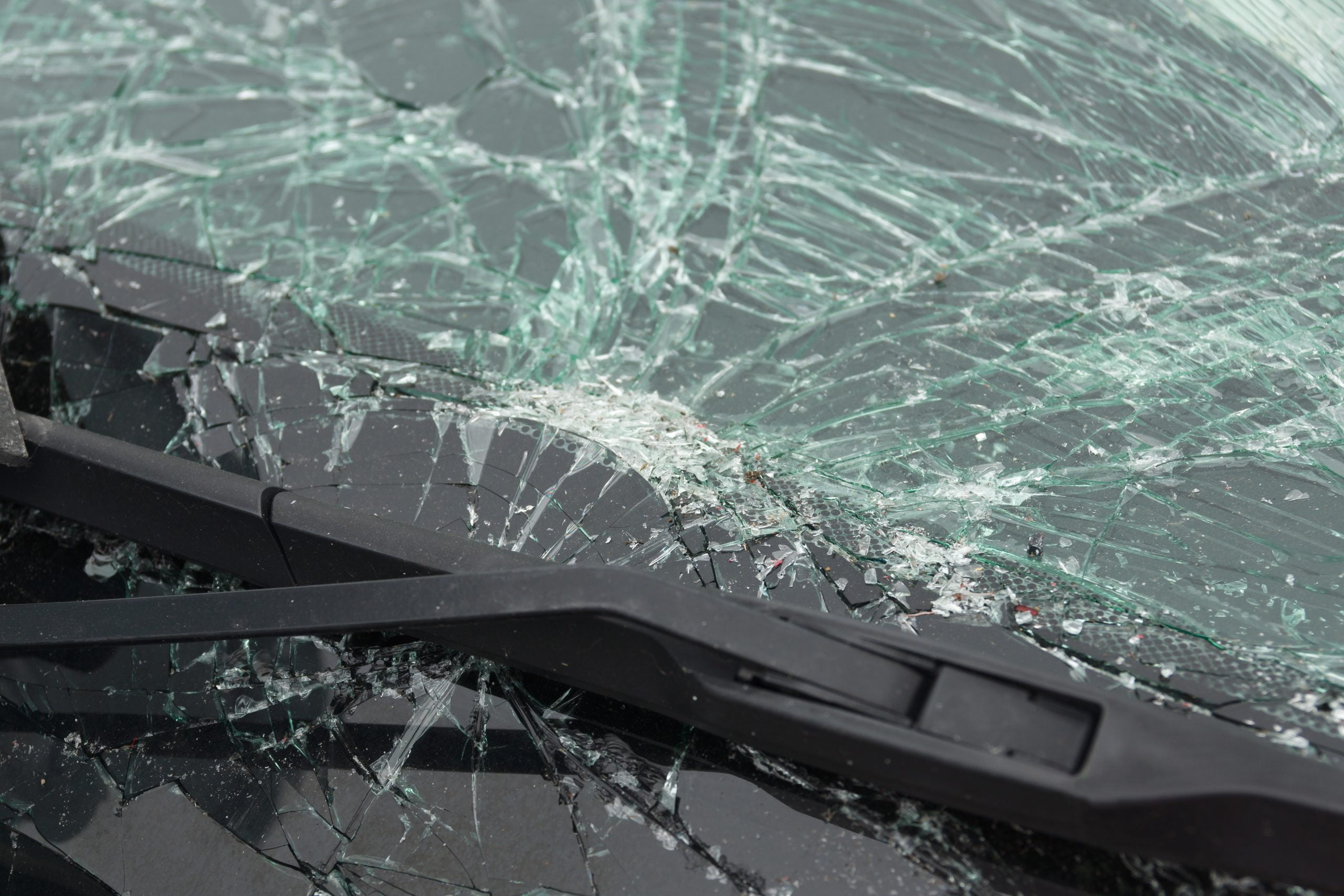 Smashed windscreen or windshield on a car in close up ideal for vehicle insurance claim or vandalism concepts