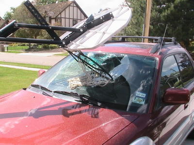 basketball hoop falling on car and breaking the windshield.