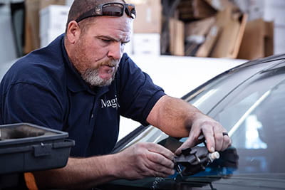 technician performing windshield repair.